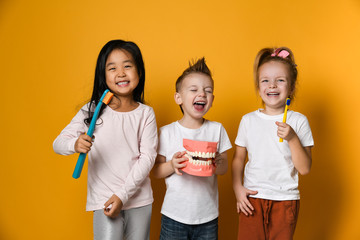 dental hygiene. happy little cute children with toothbrushes.