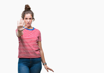 Poster - Beautiful brunette curly hair young girl wearing casual look over isolated background doing stop sing with palm of the hand. Warning expression with negative and serious gesture on the face.