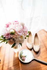 Wall Mural - Bride's shoes next to the wedding bouquet.