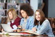 © Africa Studio - Group of students studying at table in library