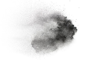 Wall Mural - black powder explosion on white background.black dust particles splash.