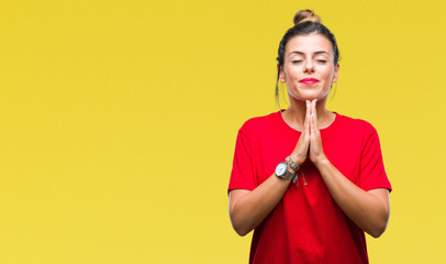 Poster - Young beautiful woman over isolated background praying with hands together asking for forgiveness smiling confident.