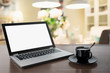 © svetlana_cherruty - Laptop with blank screen with coffee on tabletop. Work at home. Coffee break. Education. E-learning.