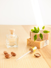 Wall Mural - Bottle with cosmetic oil argan nuts. Cosmetic means. Food product. Jar with argan oil and handmade soap on the wooden background