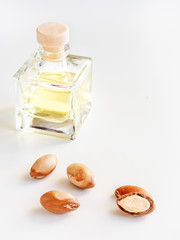 Wall Mural - Bottle with valuable oil argan nuts. Cosmetic means. Food product. Jar with argan oil on the isolated background