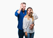 © Krakenimages.com - Young couple in love over isolated background doing ok gesture shocked with surprised face, eye looking through fingers. Unbelieving expression.