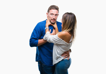 Wall Mural - Young couple in love over isolated background shouting and suffocate because painful strangle. Health problem. Asphyxiate and suicide concept.