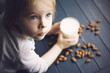 Little girl holding glass of vegan milk.