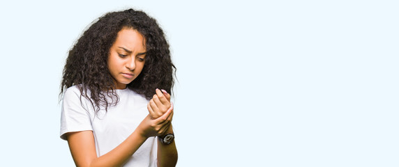 Sticker - Young beautiful girl with curly hair wearing casual white t-shirt Suffering pain on hands and fingers, arthritis inflammation