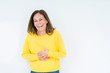 © Krakenimages.com - Beautiful middle age woman wearing yellow sweater over isolated background Smiling and laughing hard out loud because funny crazy joke. Happy expression.