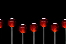 Red Lollipops Pattern On Black Background, Copy Space