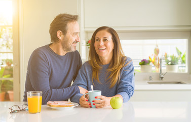 Beautiful romantic middle age couple having healthy breaskfast in the morning at home