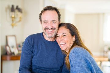 romantic middle age couple sitting together at home