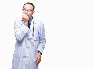 Poster - Middle age senior hoary doctor man wearing medical uniform isolated background looking stressed and nervous with hands on mouth biting nails. Anxiety problem.