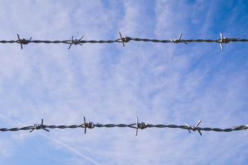 Barbed wire with sky