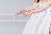 Exercises In The Ballet School. Ballet Classes. A Group Of Girls Standing In A Row, Stretched Out Their Arms. Children In White Dresses For Dancing. Rukapa Raised In Line, Brush Slightly Down.