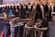 Row of bridles in a tack room on a horse riding farm