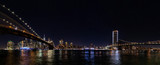 Fototapeta Nowy Jork - Night wide angle panorama Manhattan panorama with Brooklyn and Manhattan bridges.