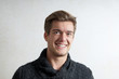 © Axel Bueckert - portrait of a smiling young man wearing warm sweater indoors