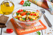 Fresh vegetable salad of mixed tomatoes of different colors. Red, yellow and brown tomatoes cut in glass bowl