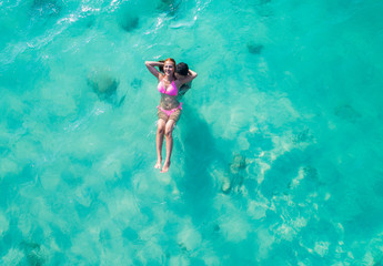 aerial top view of the couple lover enjoy swimming in the cleared and clean of seawater, happy holidays vacation and valentine occasion