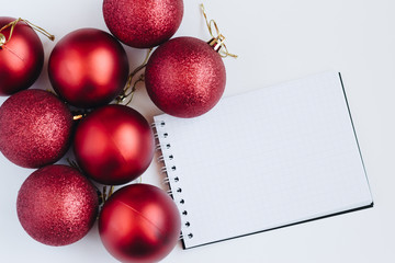 Top view on empty sheet of notebook and christmas balls