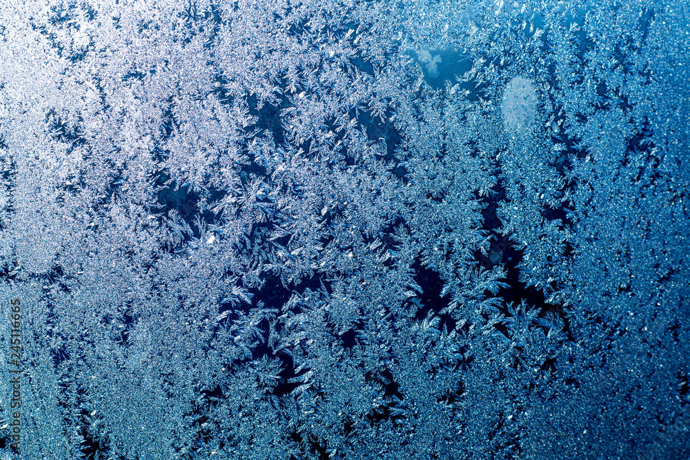 Window Ice Pattern Cold Ice patterns on glass, frost on a winter window, fancy patterns of ...
