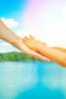 © Kostia - hands of a parent and child in nature in a park by the sea