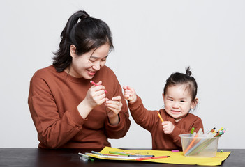 Wall Mural - Asian kid and her mother, drawing and playing together