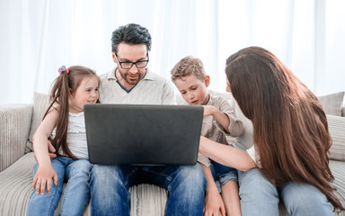 modern family looking at the laptop screen.