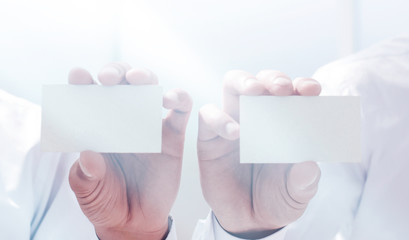 close up.two businessmen showing their business cards