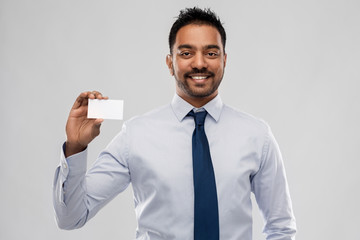 Sticker - business, office worker and people concept - smiling indian businessman holding visiting card over grey background