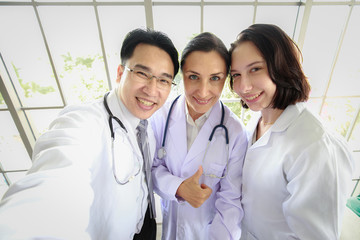 Group of three person, doctor and assistant, take a selfie photo together with happiness and smiling faces. Concept for successful team.