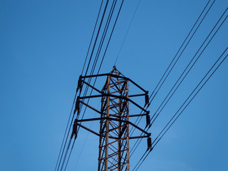 low angle high voltage electric pole with blue sky