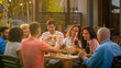 © Gorodenkoff - Big Family Garden Party Celebration, Gathered Together at the Table Relatives and Friends, Young and Elderly are Eating, Drinking, Passing Dishes, Joking and Having Fun.