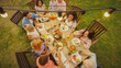 © Gorodenkoff - Big Family Garden Party Celebration, Gathered Together at the Table Relatives and Friends, Young and Elderly are Eating, Drinking, Passing Dishes, Joking and Having Fun. Top Down Shot.