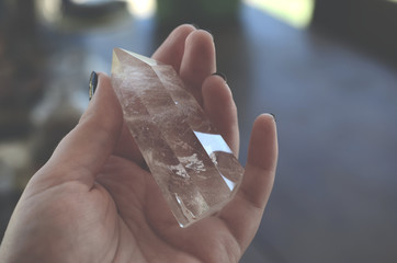 Beautiful, bright tumbled crystal chips. Stunning healing crystals. Macro photograph, low exposure. Hand holding crystals, bright healing crystals. Crisp colors and lighting, clear quartz, opalite