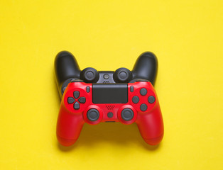 Two joysticks on a yellow background. top view.