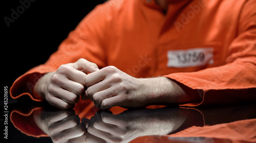 Fotomural Arrested person hands closeup, prisoner talking to lawyer during interrogation