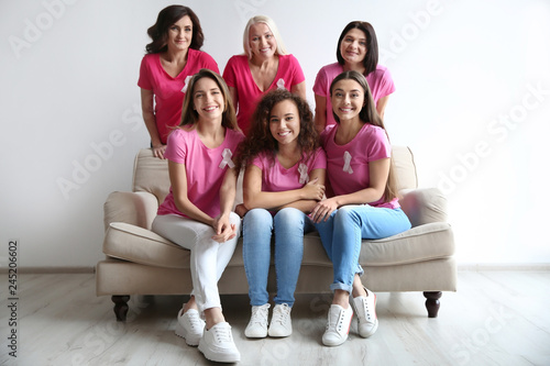 Fotografía Group of women with silk ribbons on sofa near light wall