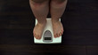 © motortion - Fat man measuring weight on scales at home, obesity problem, sedentary life