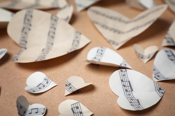 Sticker - Paper hearts with music notes on color background