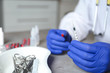 © New Africa - Doctor holding syringe at table, closeup with space for text. Medical objects