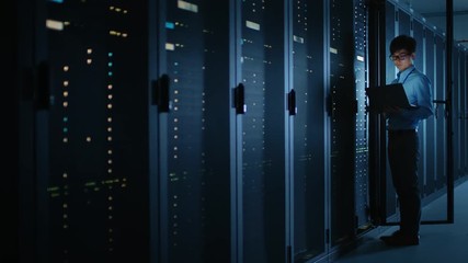 Aufkleber - Dark Data Center: Male IT Specialist Stands Beside the Row of Operational Server Racks, Uses Laptop for Maintenance. Concept for Cloud Computing, Artificial Intelligence, Supercomputer, Cybersecurity