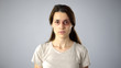 © motortion - Bruised lady looking at camera, sexual assault victim, rehabilitation center