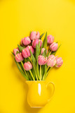 Fototapeta Tulipany - Fresh pink tulips in a jug, close up