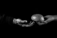 Woman giving Bread to poor man in need. Helping Hand Concept. Black and white