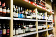 Defocused picture of shelves with bottles of wine