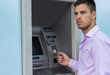 © sanjagrujic - Young businessman withdrawing money from a cash machine