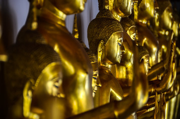 Golden buddha figures in a row